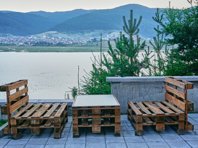 DIY outdoor decor: DIY pallet furniture on a patio overlooking a body of water