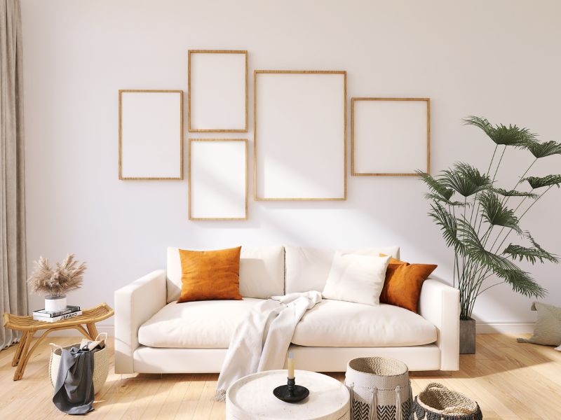 DIY accent wall ideas: a minimalist gallery wall with empty wooden frames above a cozy sofa, ready for creative customization