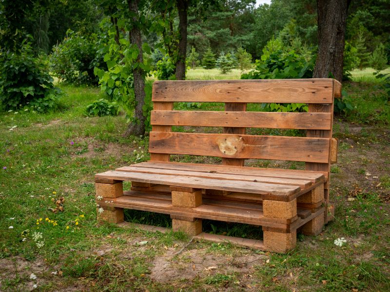 DIY garden projects: a handcrafted garden bench made from reclaimed wooden pallets, perfect for outdoor relaxation