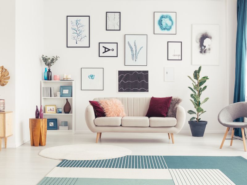 Affordable DIY projects: a stylish gallery wall with framed artwork and photos, adding personality to a modern living room