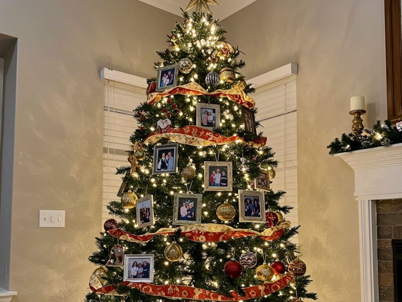 christmas ornament: photo frame ornaments with family pictures hanging on a Christmas tree, adding personal holiday charm